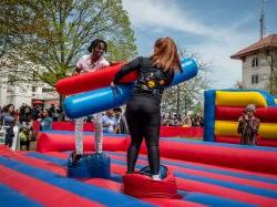 Two students playing in an inflatable jousting arena